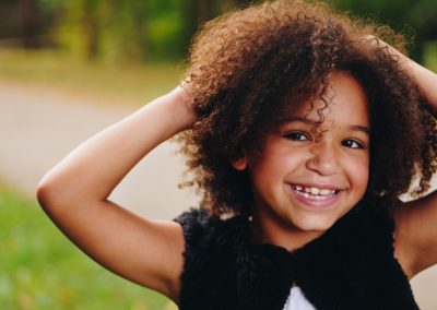 Young Girl smiling after receiving new clothes